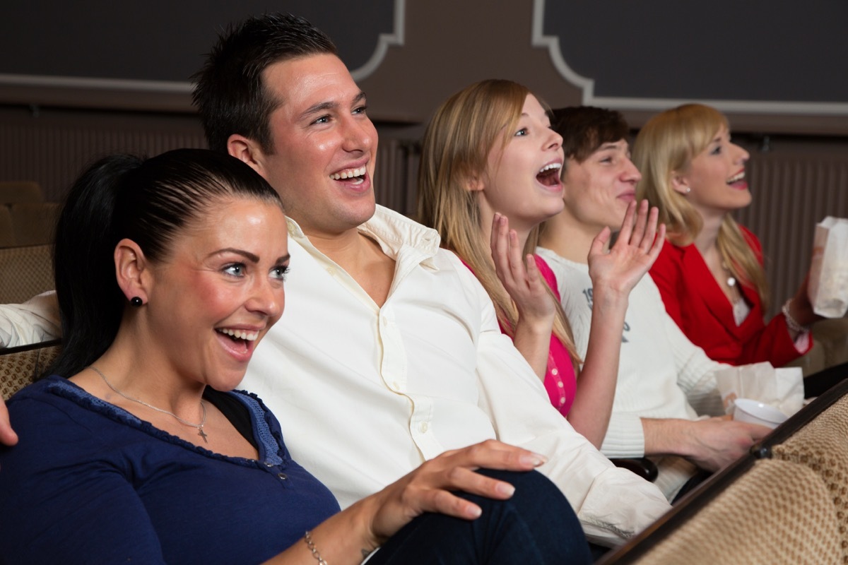 Family laughing in audience of a comedy show