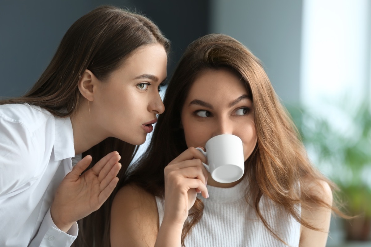 woman whispering gossip