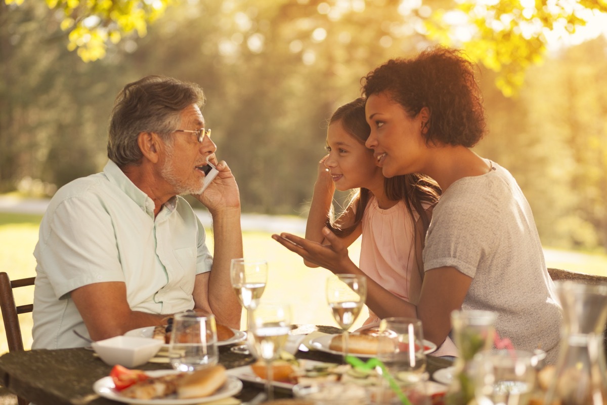 Senior man, his granddaughter and her mother on a family picnic