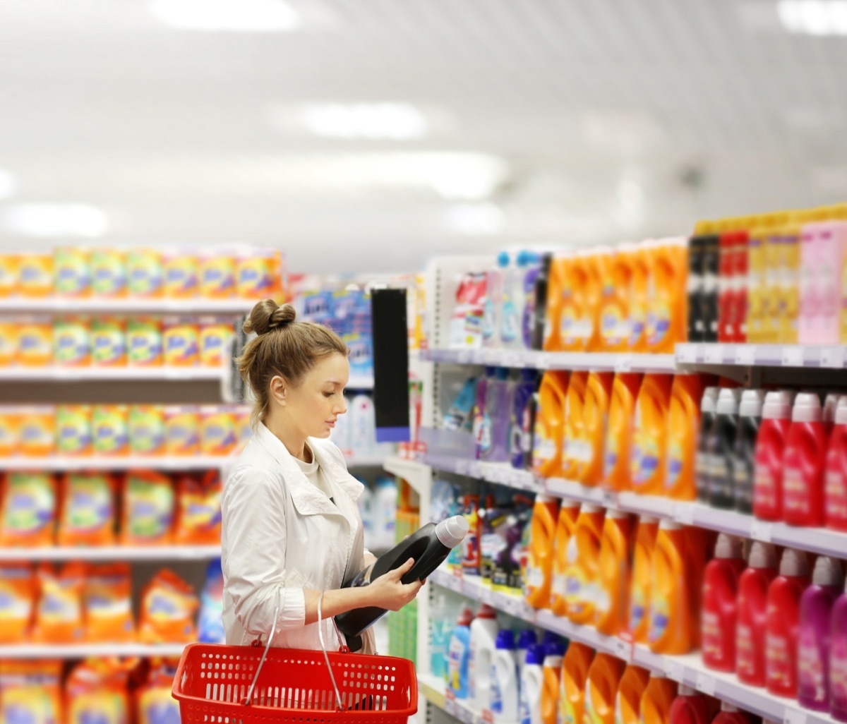 woman shopping and looking at detergent