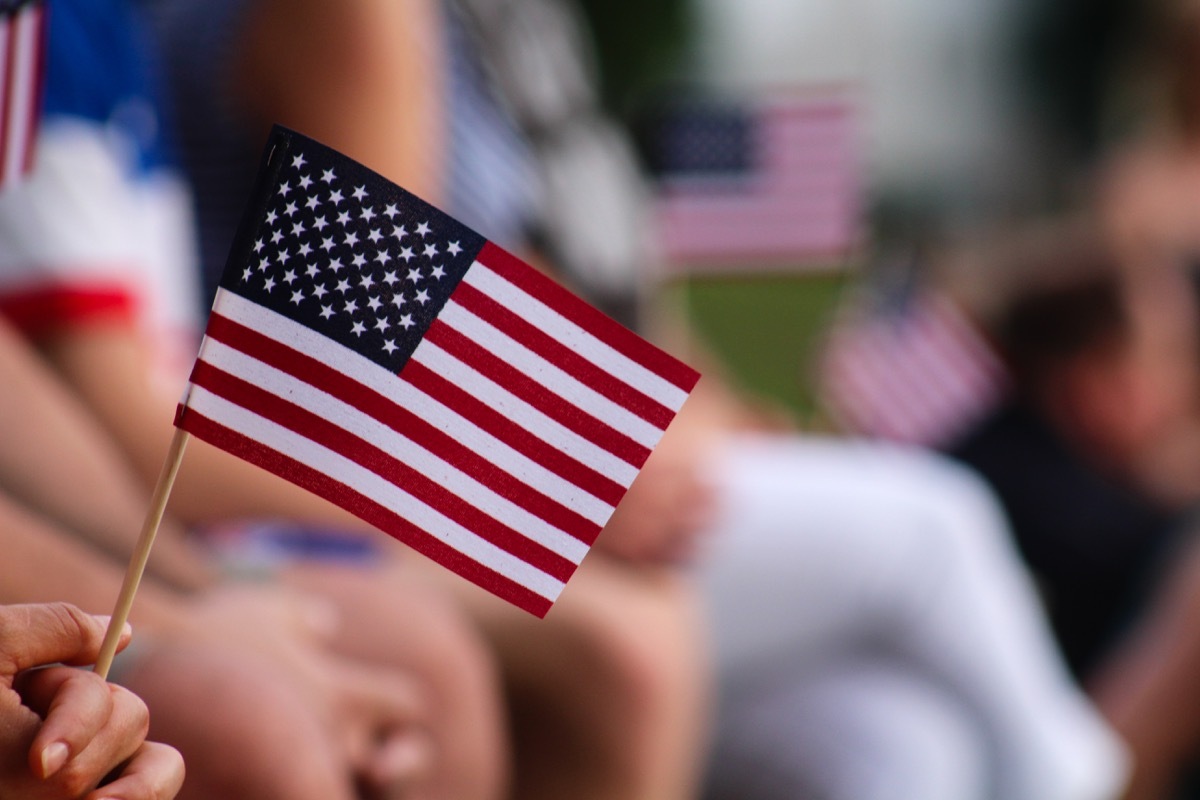 American Flag being held by someone