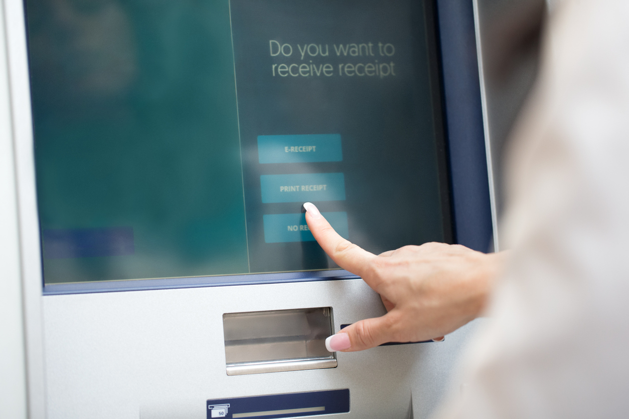 close-up of white hand touching ATM