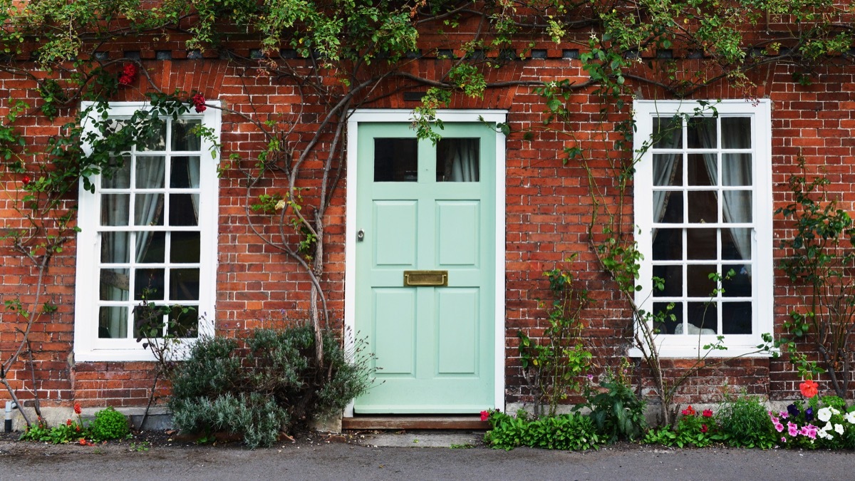 Mint painted door brick house