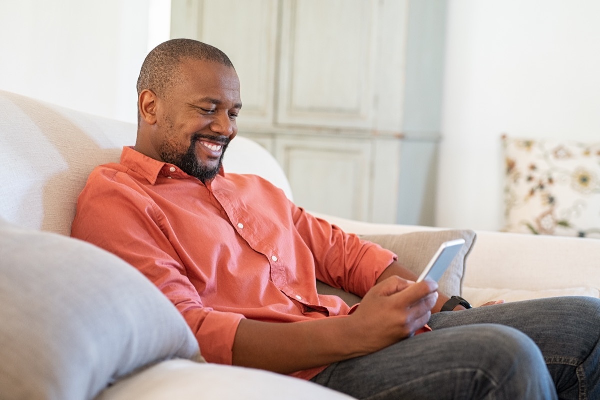 man typing on his phone