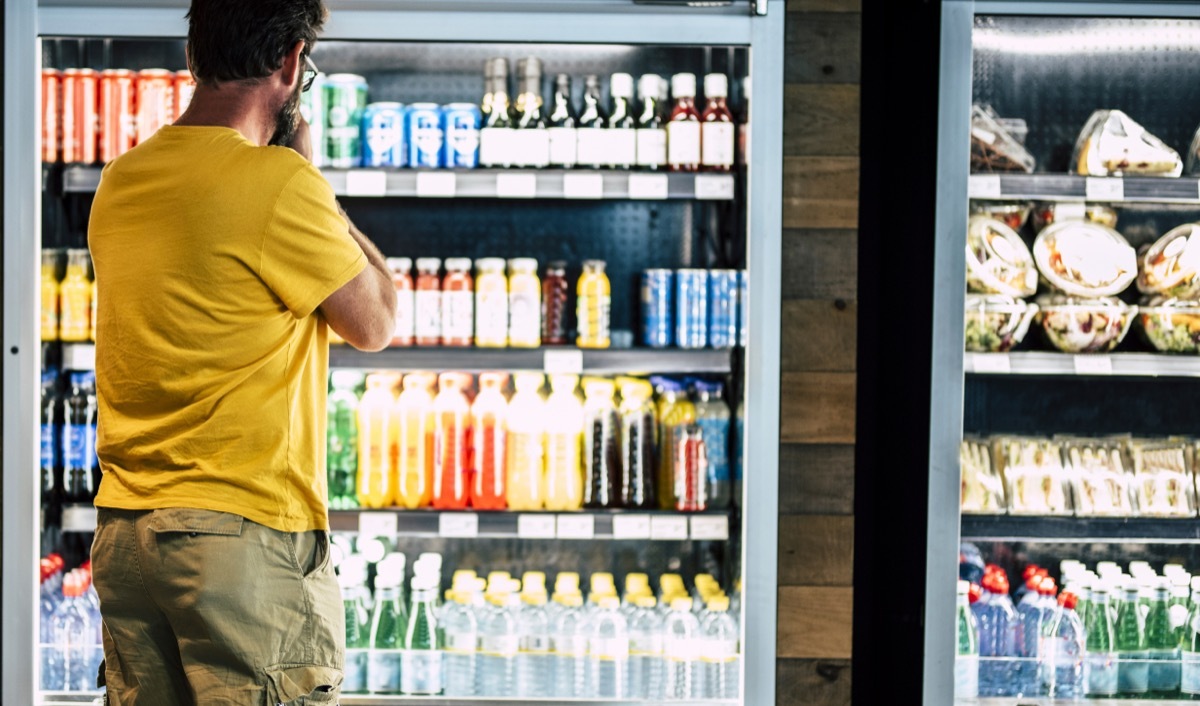 man looking at drink selection