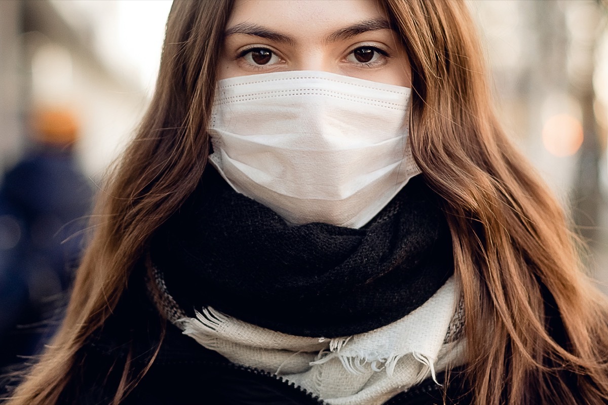 Woman wearing a face mask on the street in a city