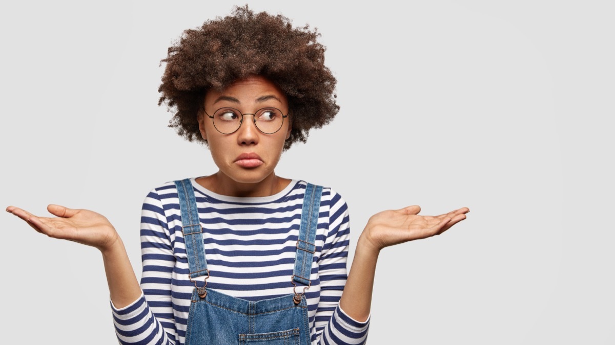 woman confused and thinking, weighing two choices ways to be less indecisive