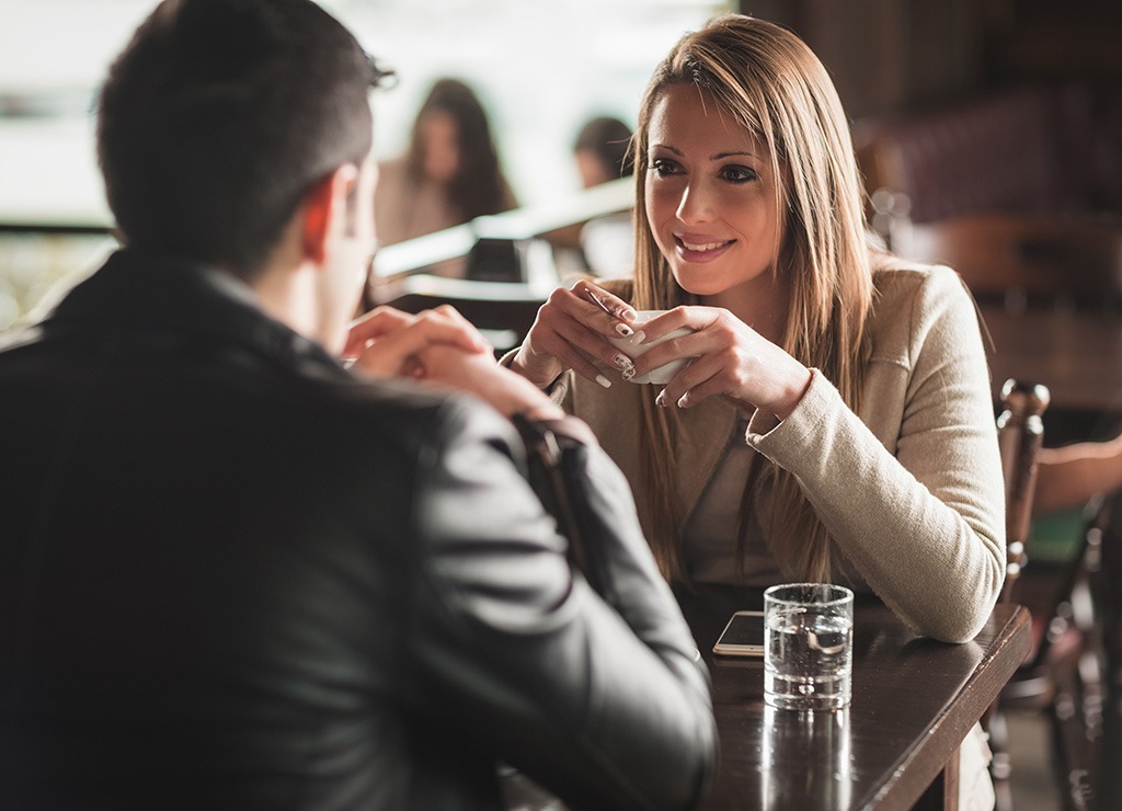 Two people talking at a restaurant