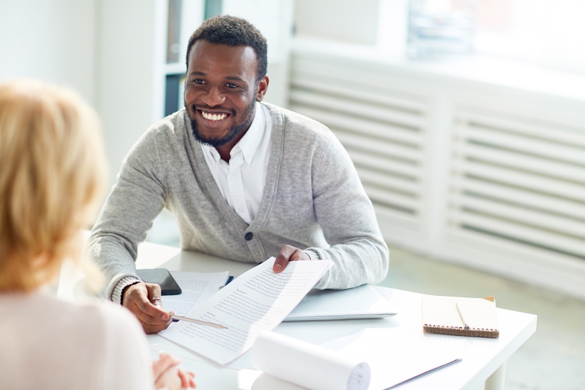 happy businessman pointing at contract