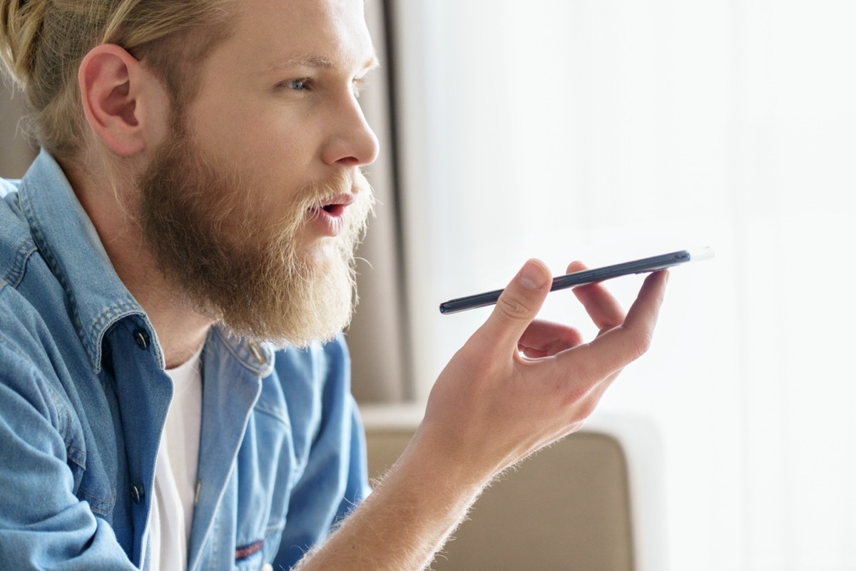 young white guy using speakerphone