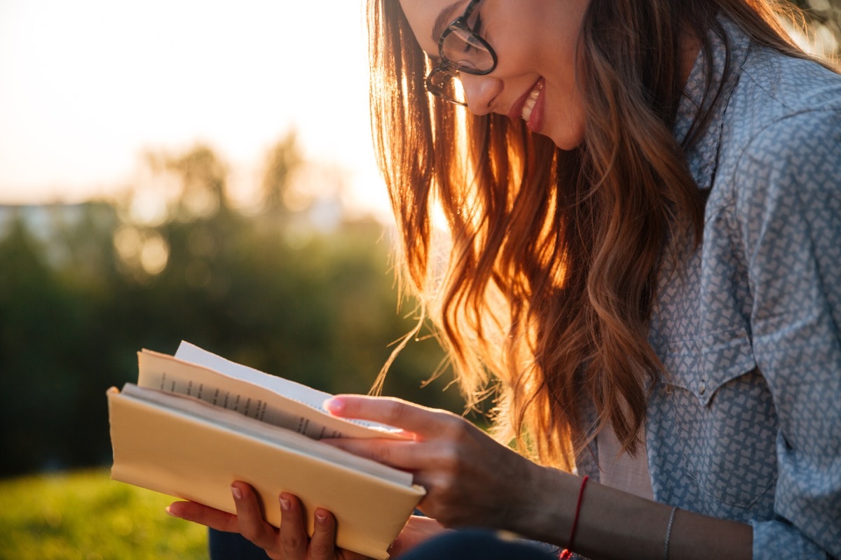 girl reading book or dictionary, new words coined