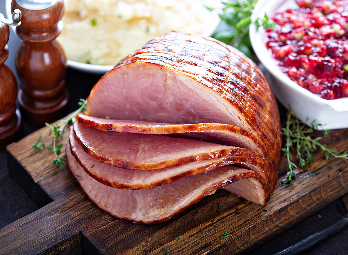 holiday glazed ham on wooden cutting board