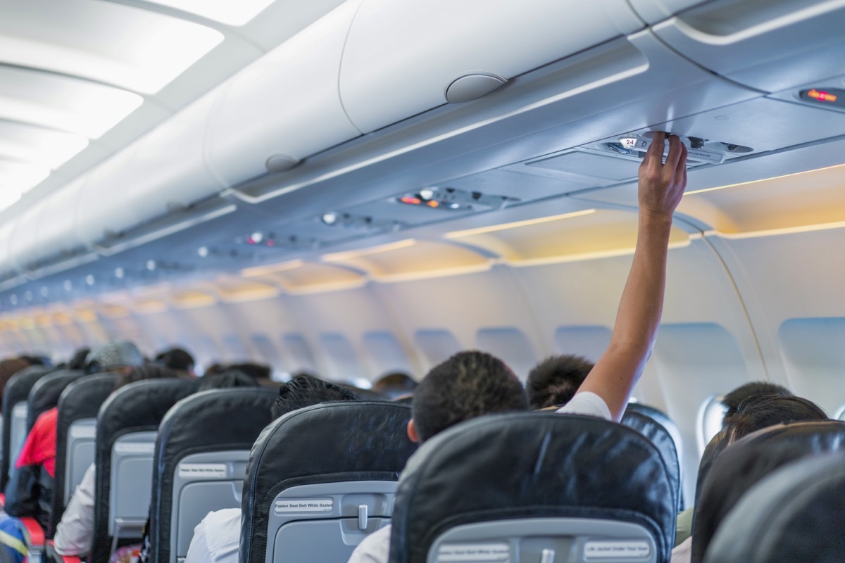 Person Adjusting Temperature on Plane