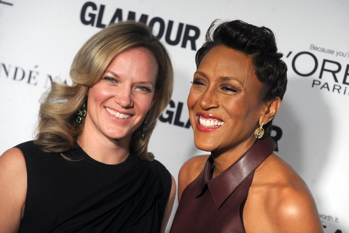 Robin Roberts wears a brown dress and Amber Laign wears a black dress at the Glamour Women Of The Year Awards in 2014