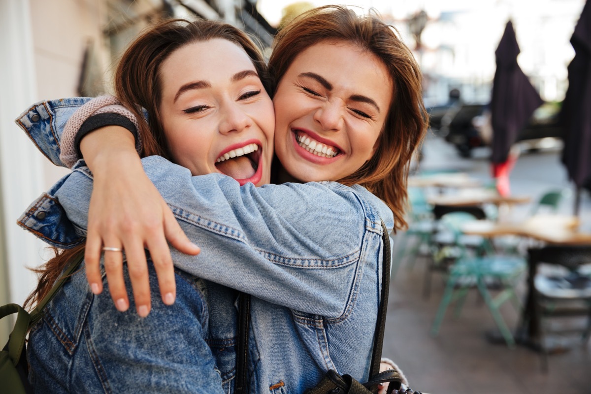 Caucasian young women hugging smiling