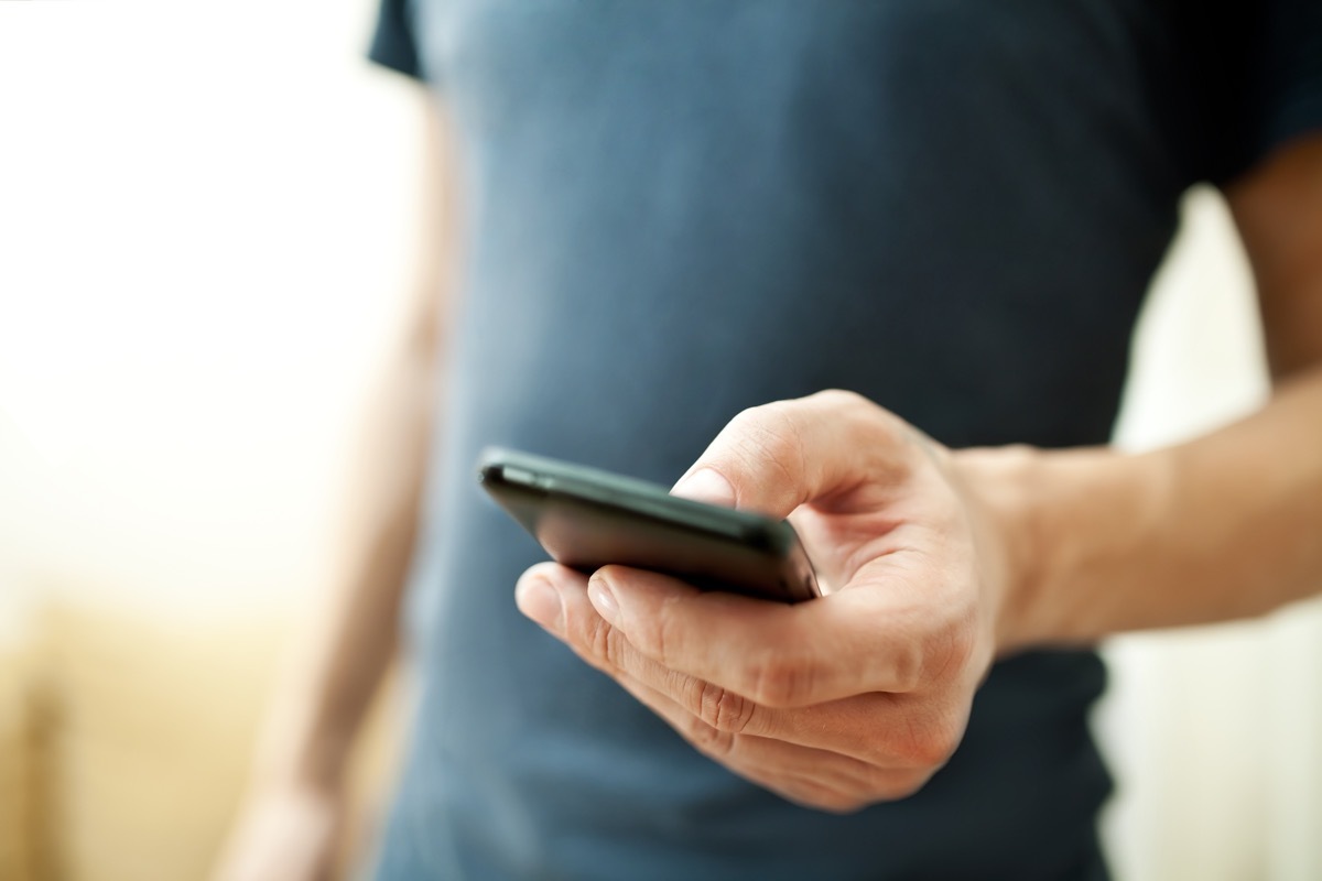 Close up on man's hand holding a smartphone