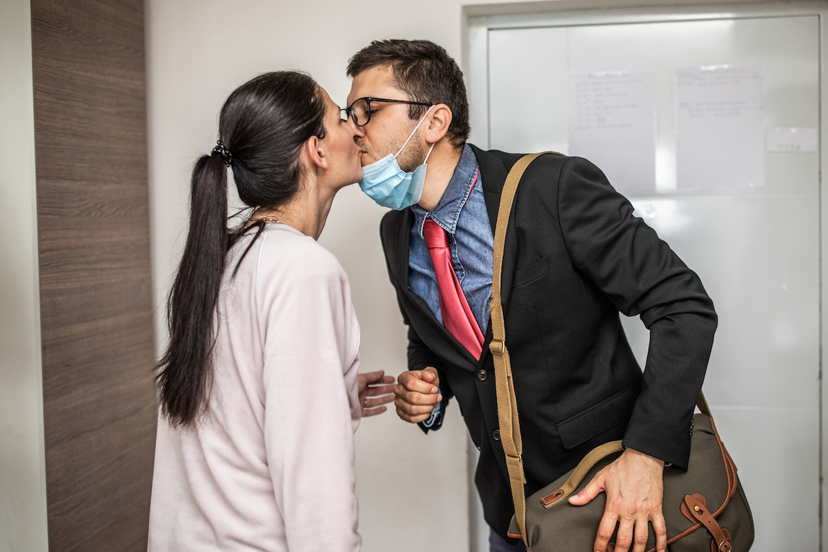 Husband arrives home after work with mask on chin