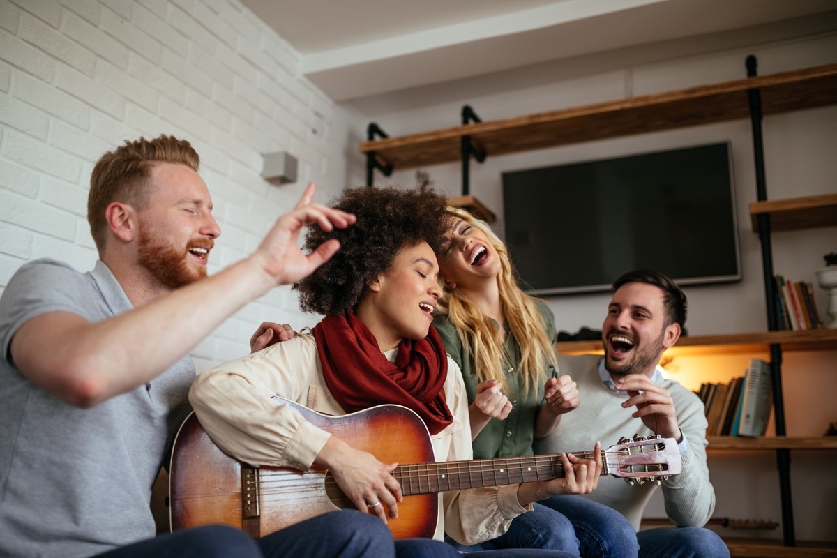 group having a jam sesh together playing guitar