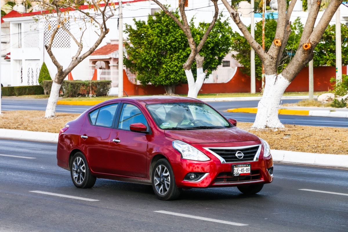 red nissan versa driving