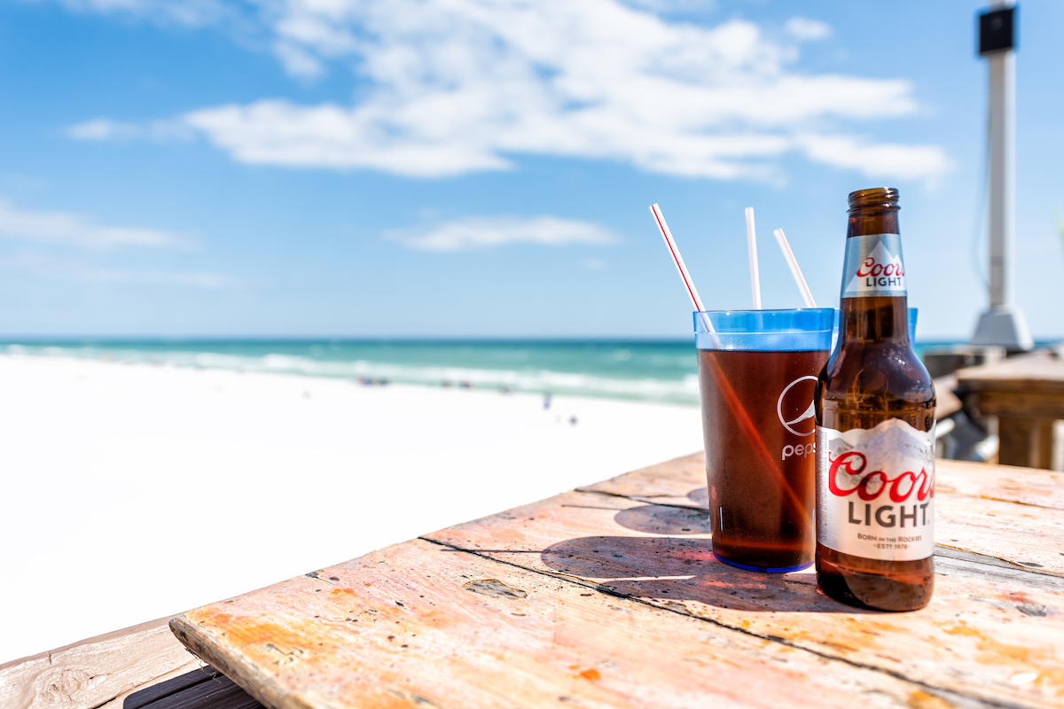 Two Coors Light beer mugs cups, straws