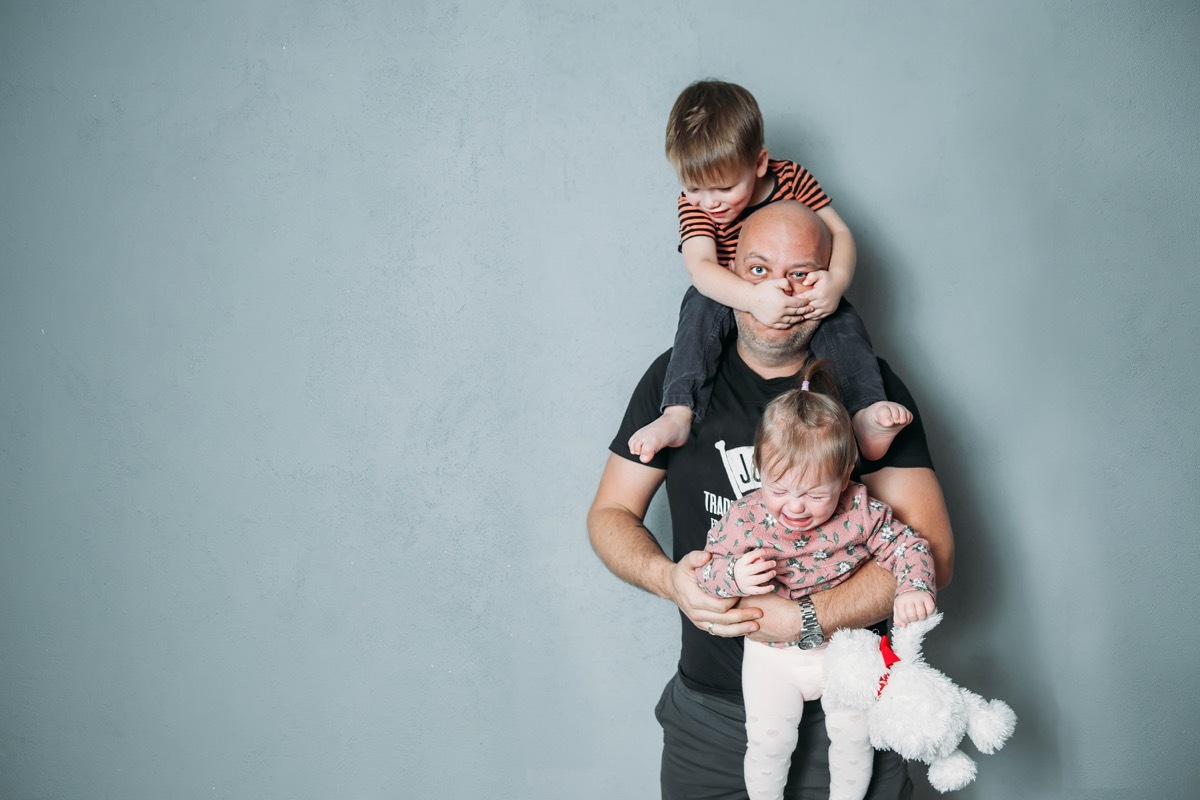 father with kids climbing all over him, ways parenting has changed