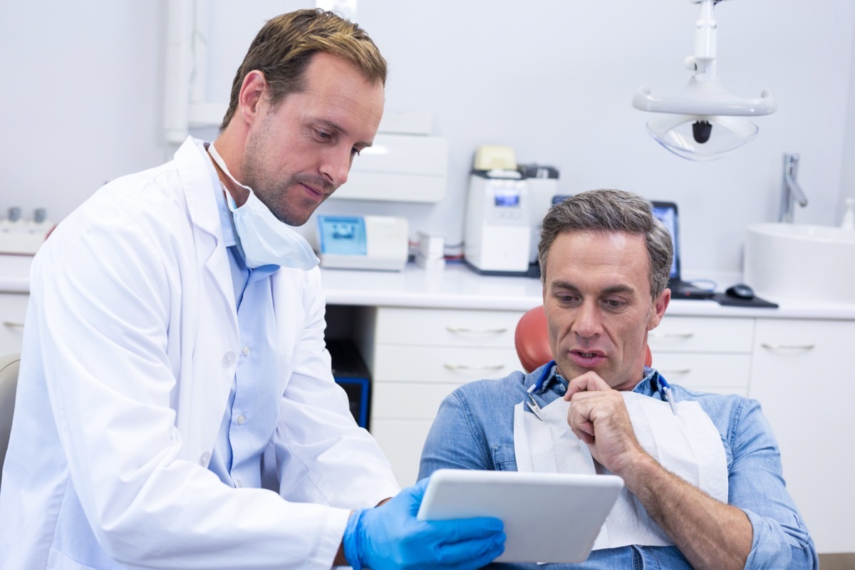 dentist shows man his test results