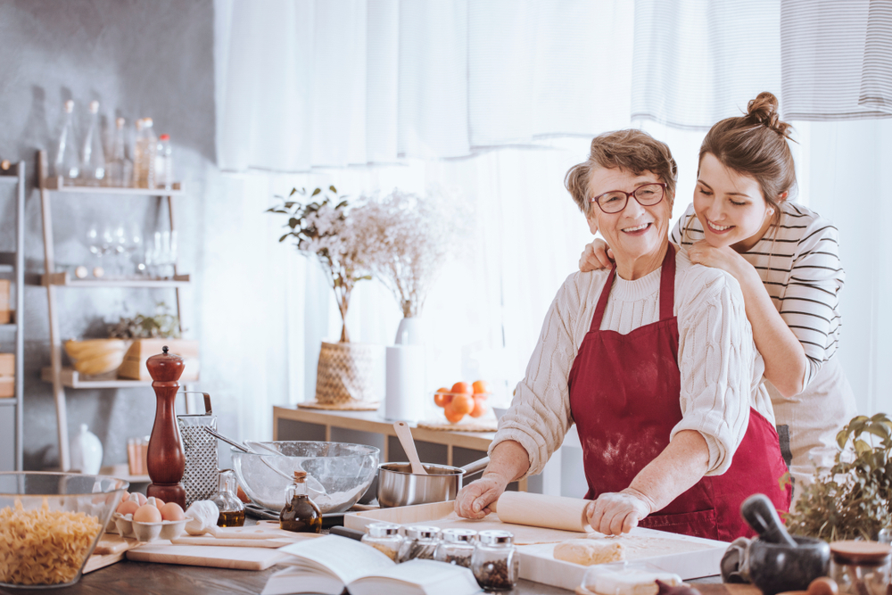 woman helps grandma cook