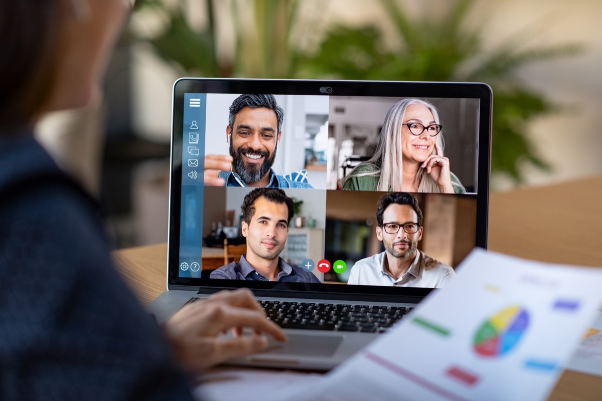 woman on five-way video call with coworkers at work