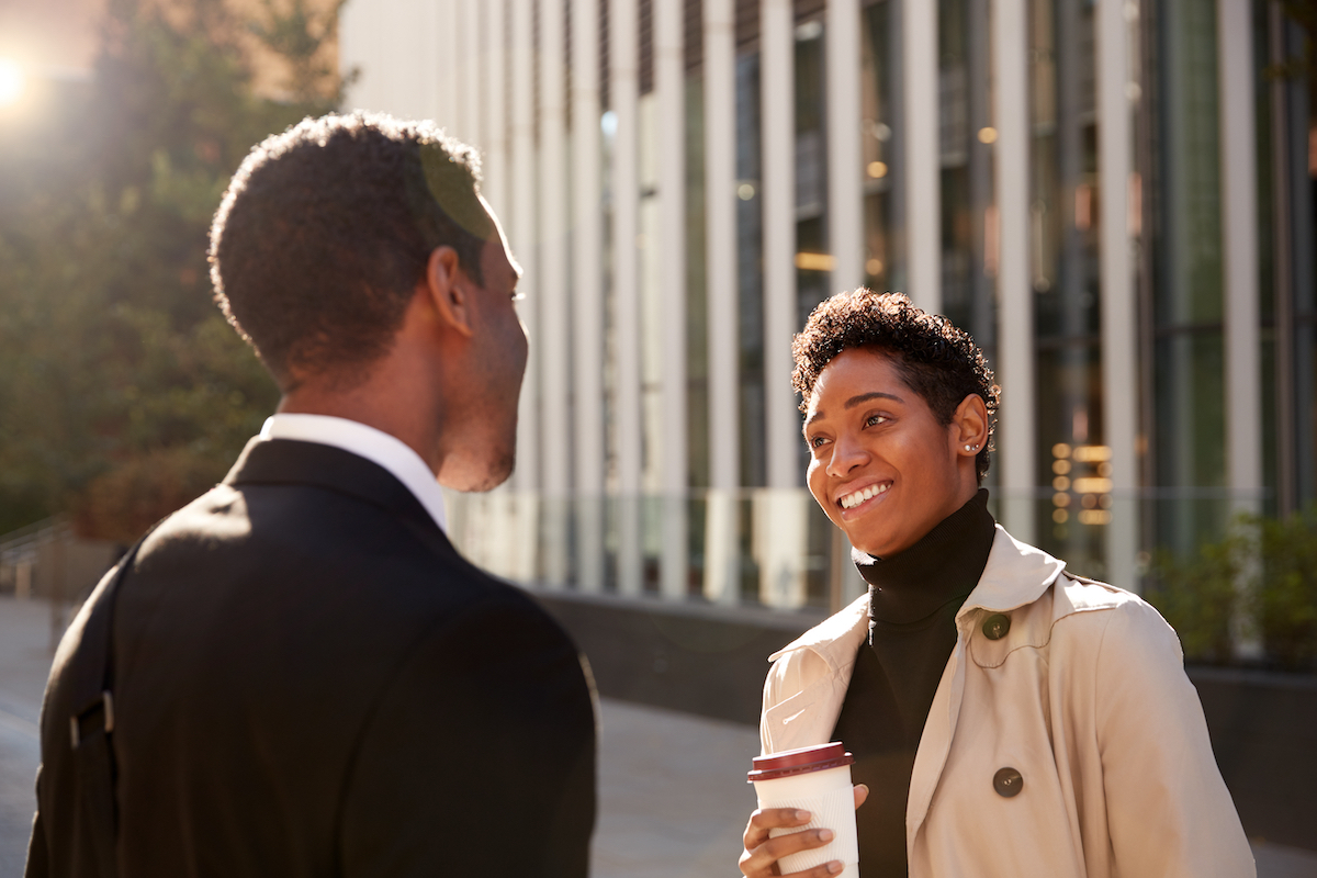 smiling woman talking to a businessman