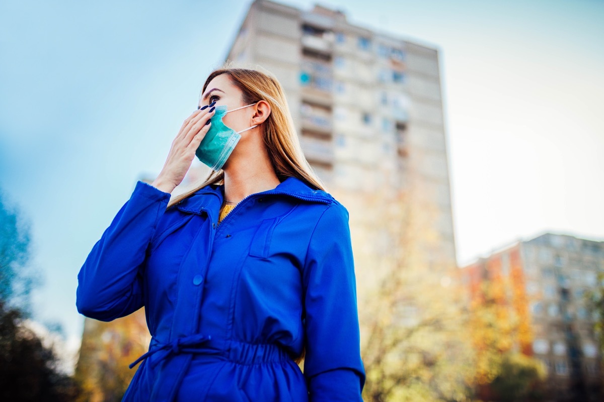 Woman wearing face mask because of air pollution or virus epidemic