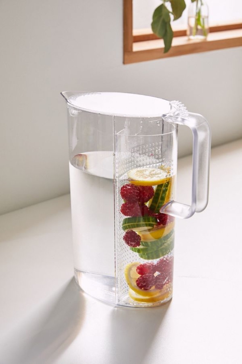 clear pitcher with fruit floating in it