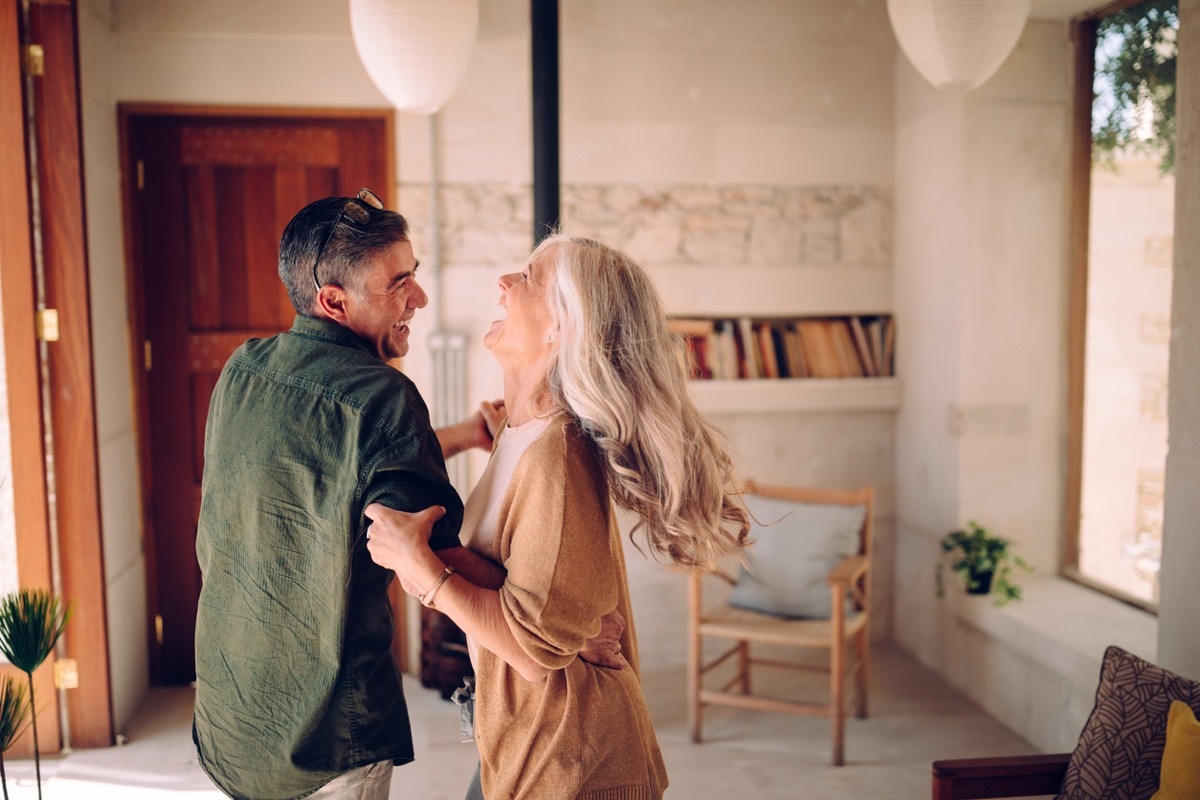 older white couple dancing at home