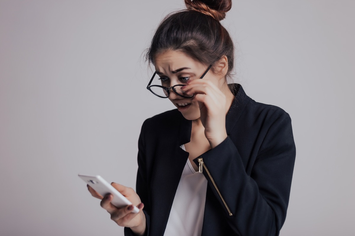 woman looking shocked at phone