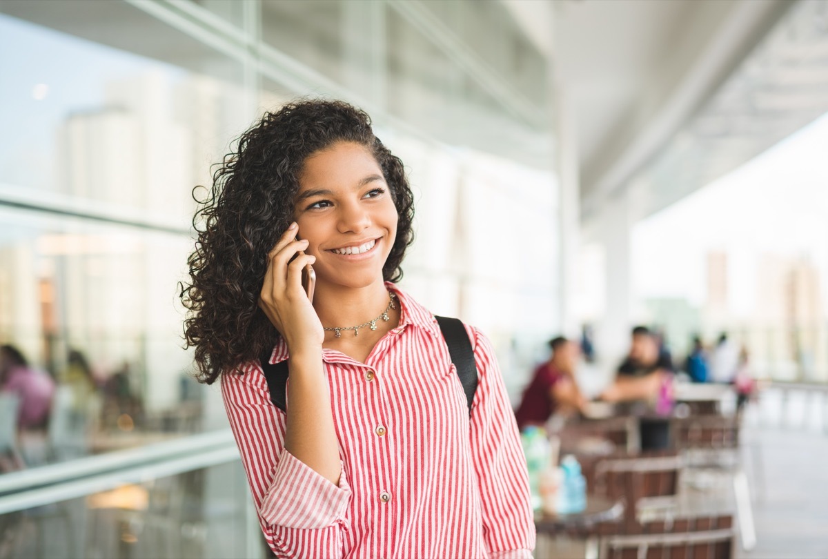 young girl calling someone on the phone