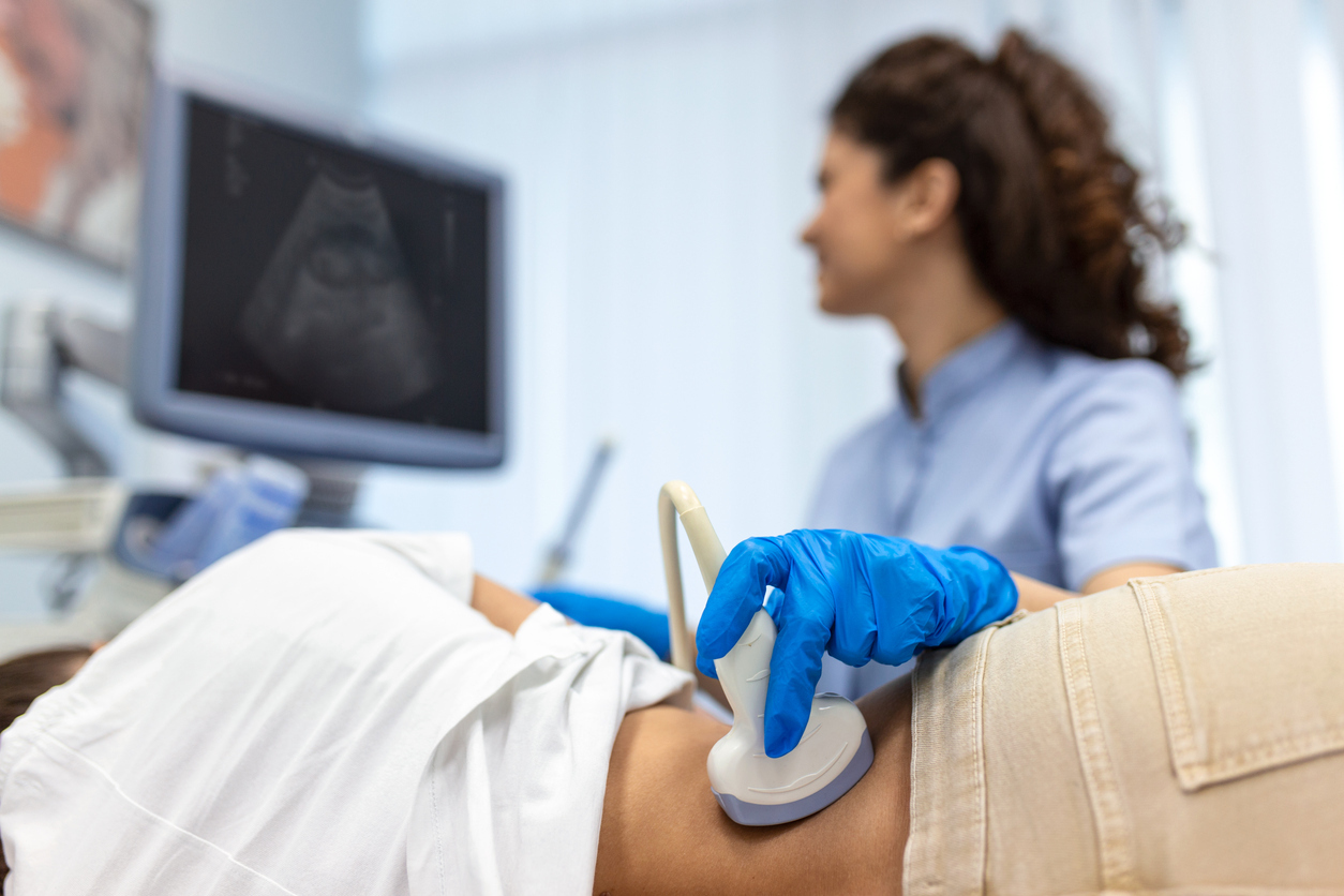 Doctor conducts ultrasound examination.