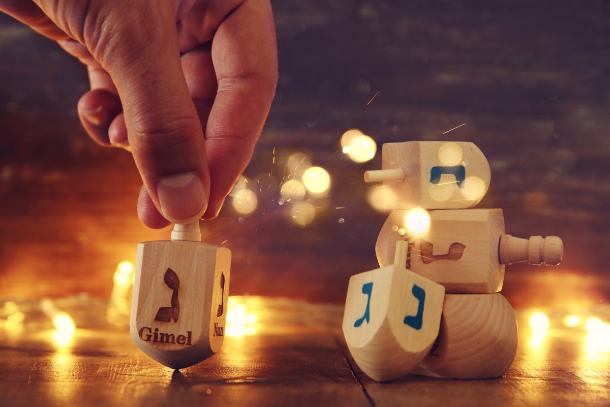 person spinning dreidel