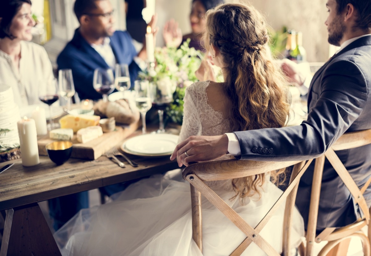 wedding couple sitting next to each other at their reception