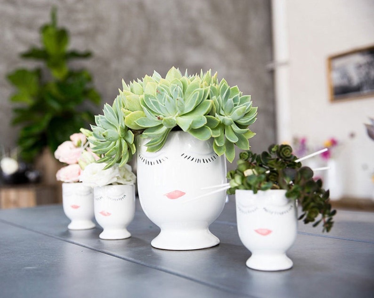 set of four ceramic planters with faces