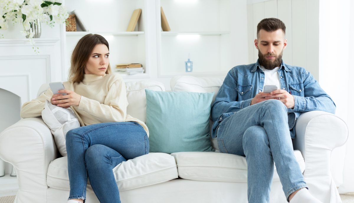 Couple on couch with cell phones