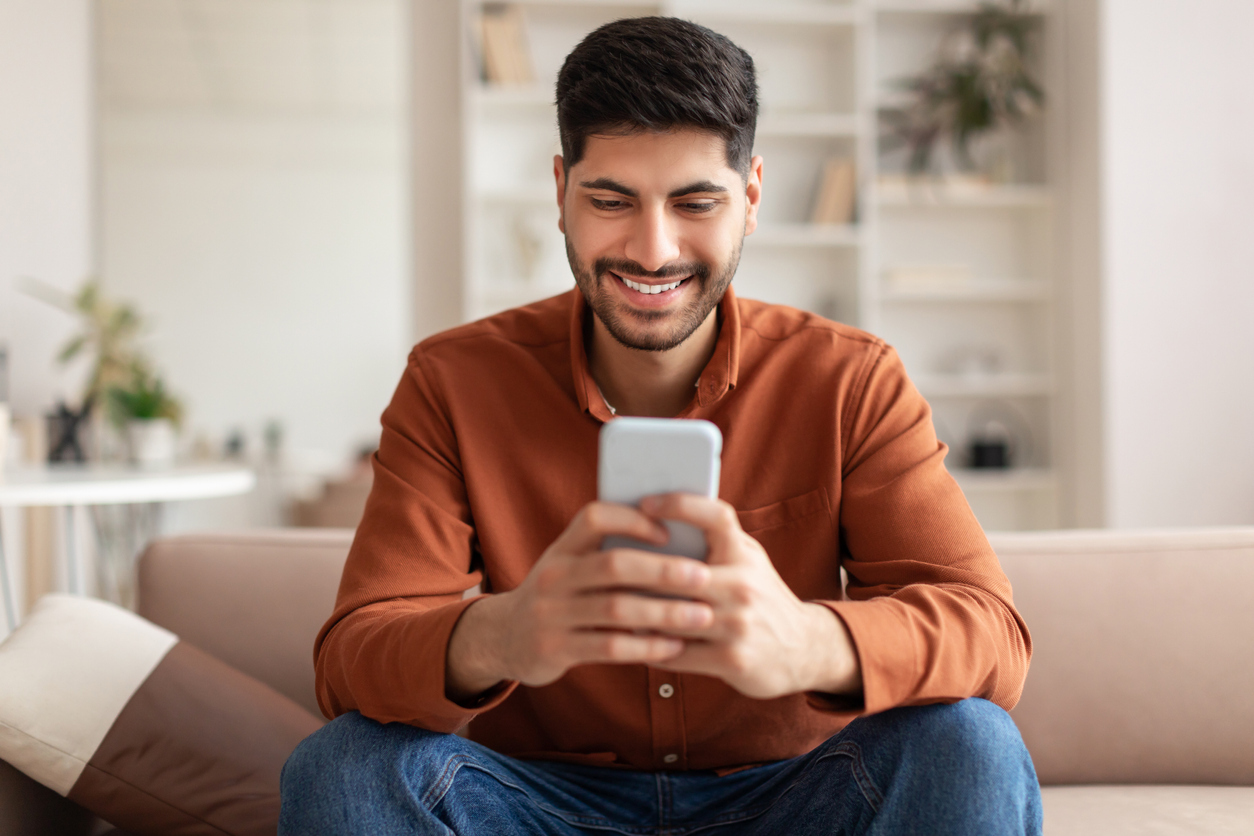 young man looking up information on his cell phone