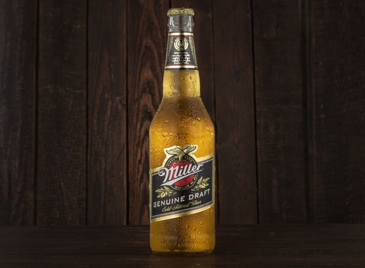 miller genuine draft beer against wood background