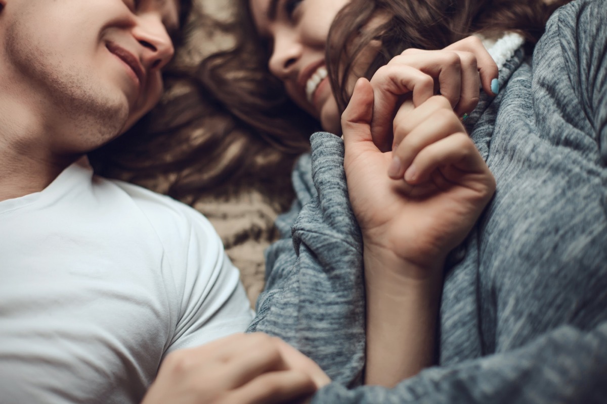 young lovers cuddling in bed