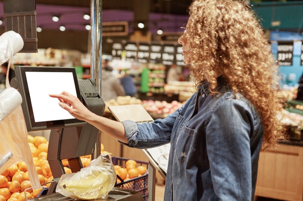 Woman Weighing Fruit Grocery Shopping Mistakes