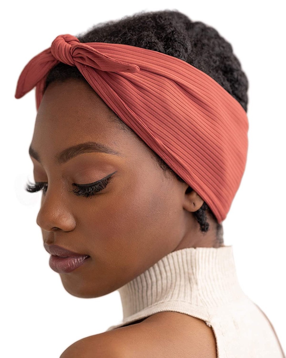 young black woman in orange hair wrap