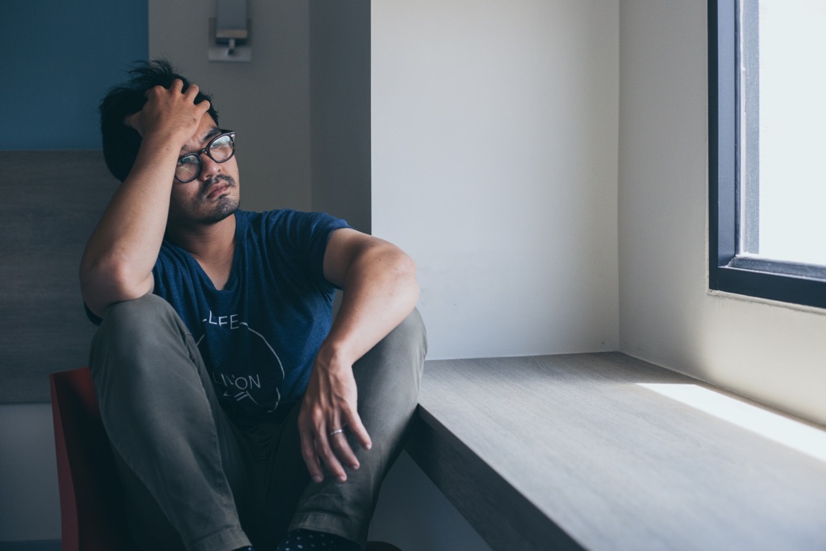 Man feeling anxious sitting down.