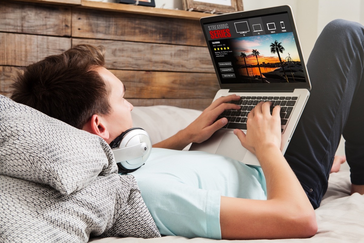 Man laying down using laptop