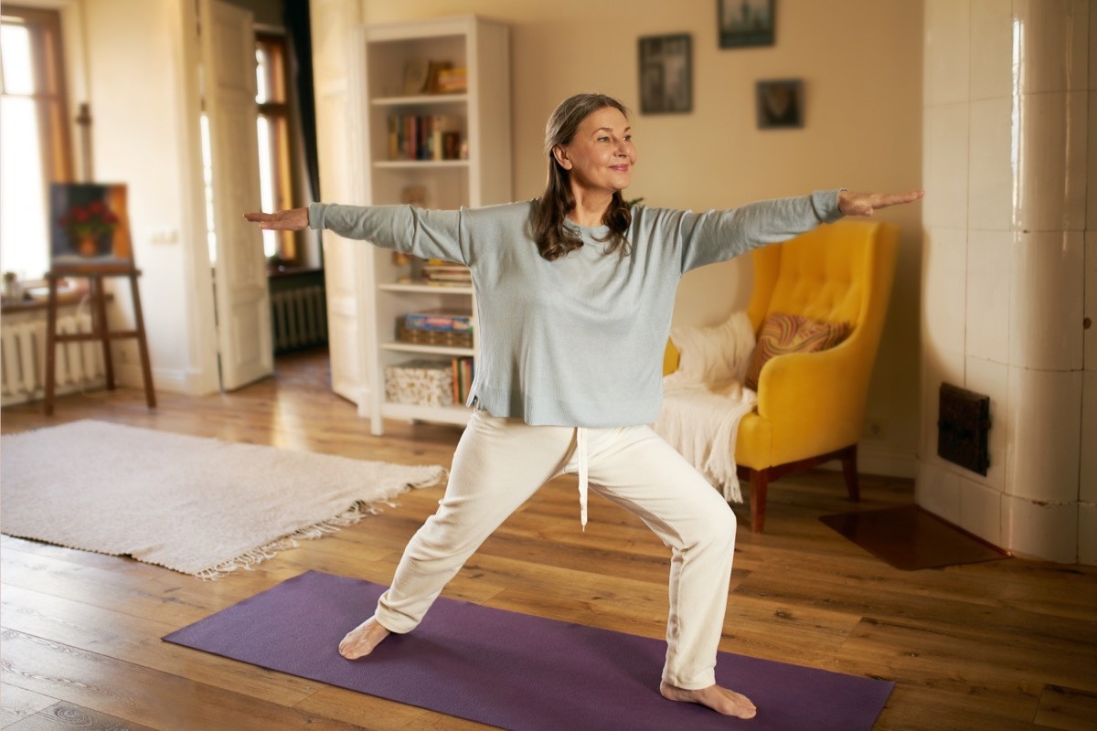 Woman doing yoga at home to reduce anxiety