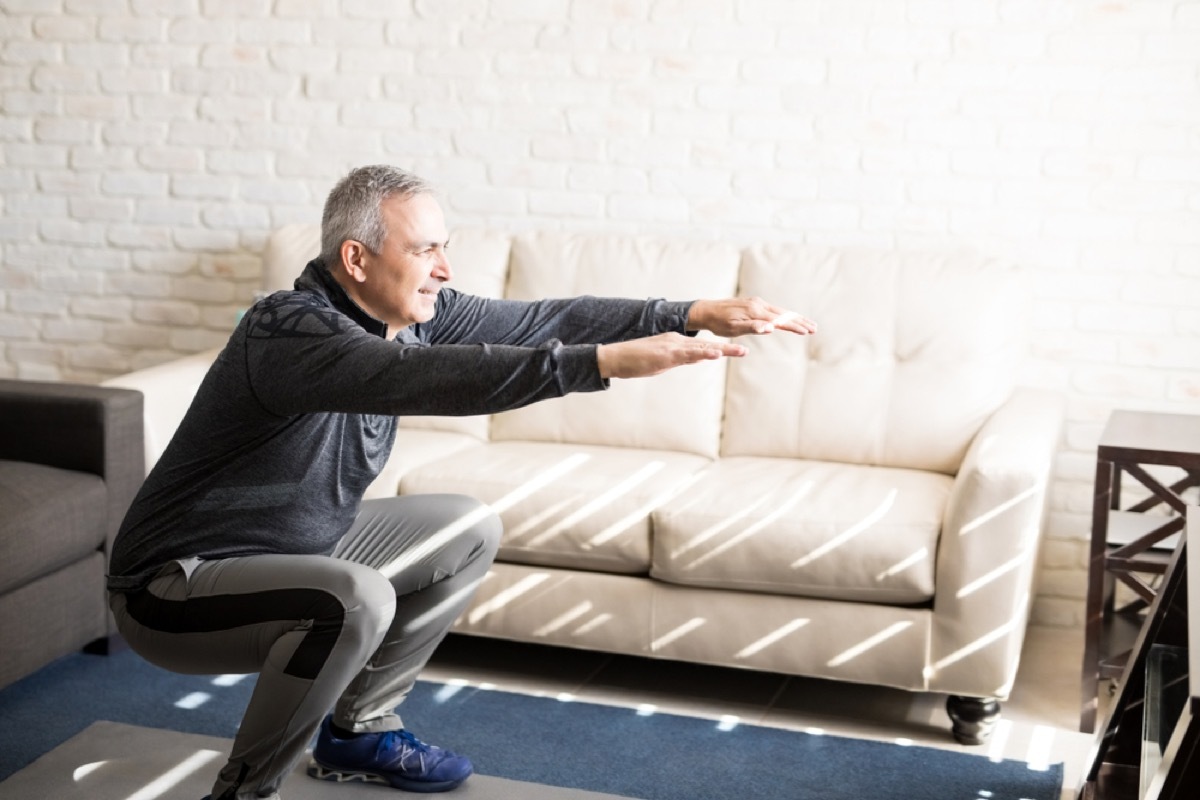 older man doing squats, health changes after 40