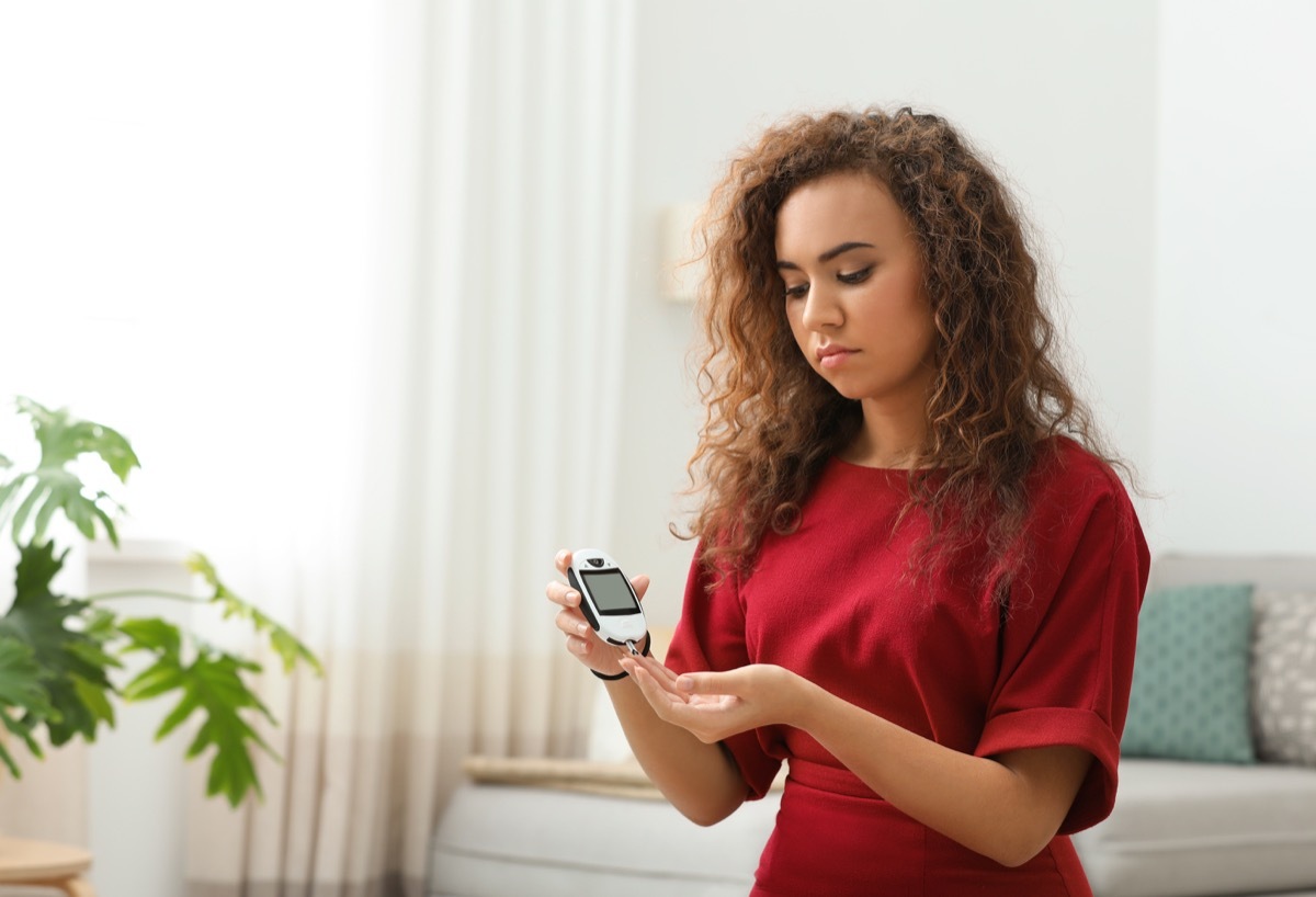 Woman doing diabetes test