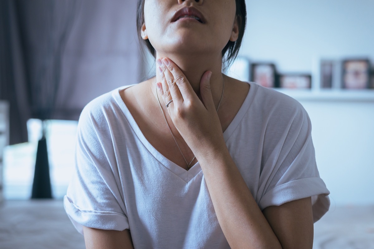 Woman holding her neck